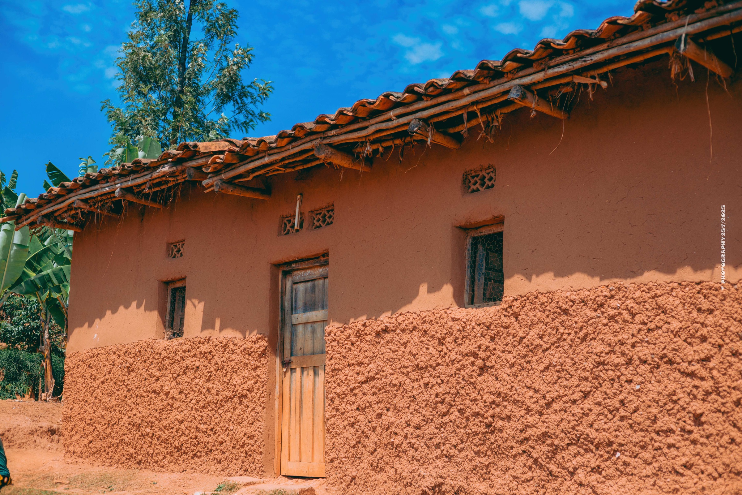 A family home and red earth in Burundi